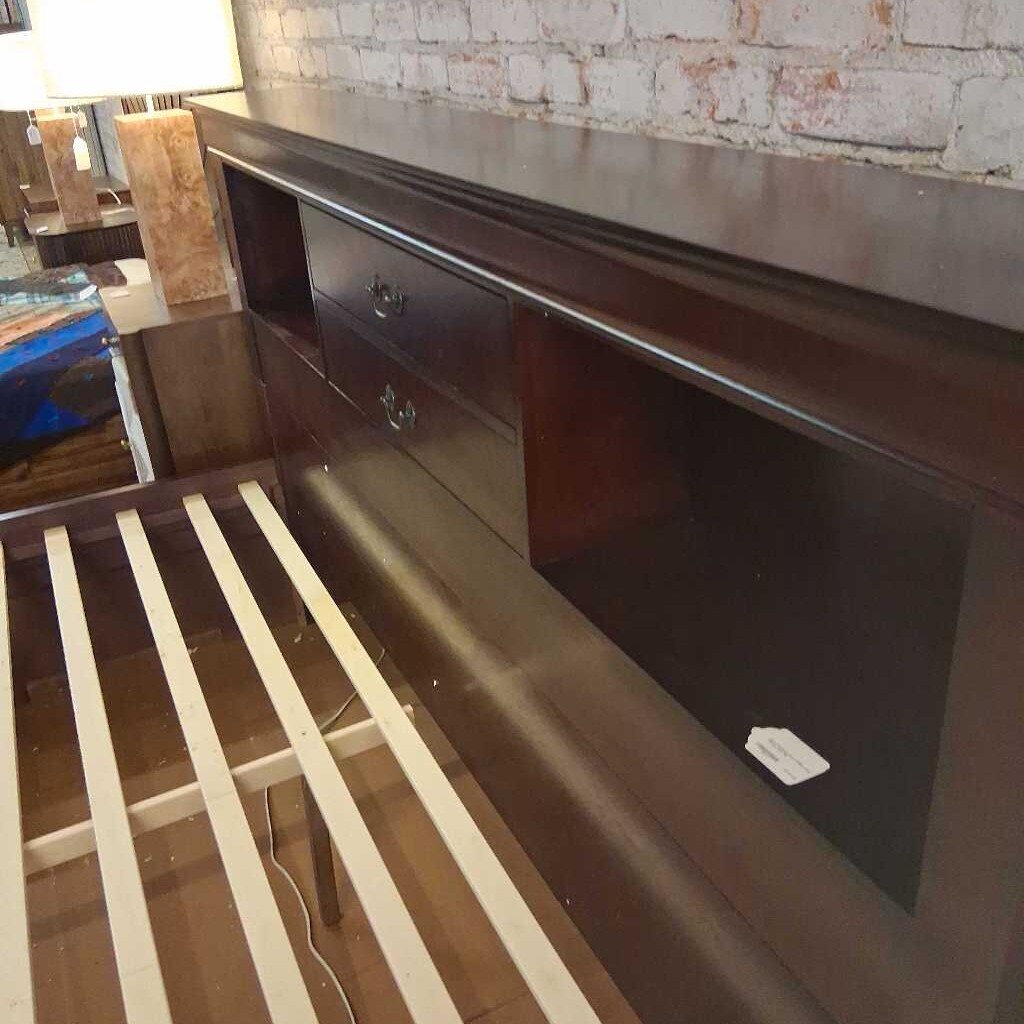 Wooden bed frame with storage drawers on a patterned rug