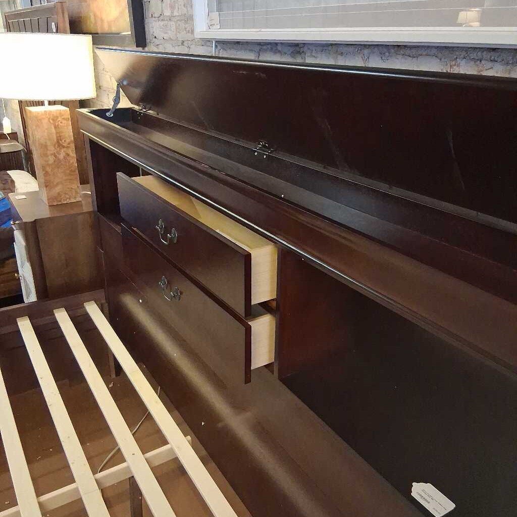 Wooden bed frame with drawers in a room setting