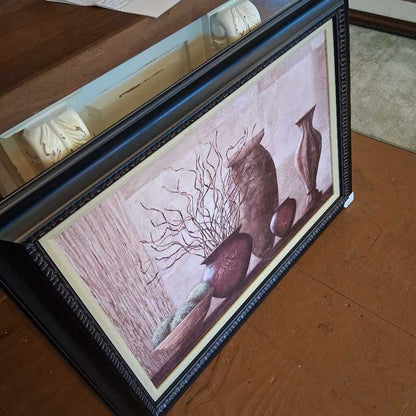Framed artwork on a wooden surface