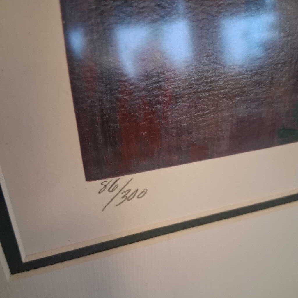 Framed artwork with a signature at the bottom right corner