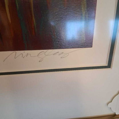 Framed artwork with a signature on a white surface