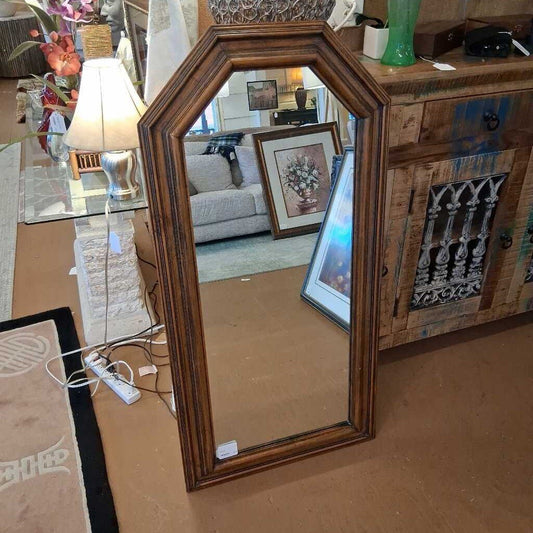 Wooden picture frame on a surface with a blurred background