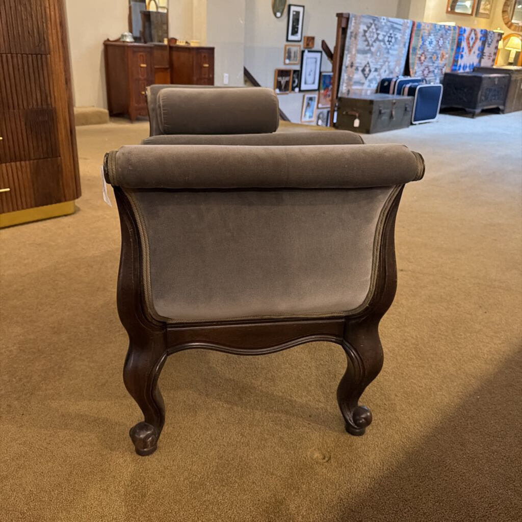 Brown upholstered armchair in a room with furniture and decor