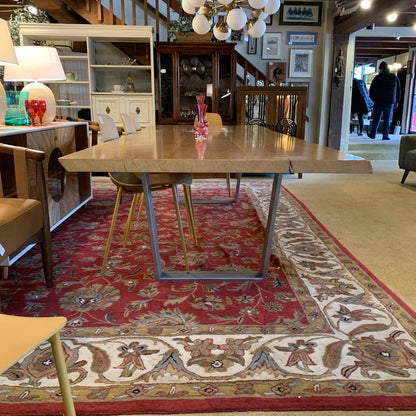 Dining room with a wooden table and chairs on a patterned rug