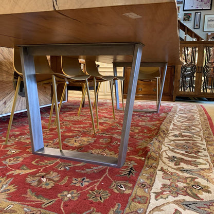 Dining table with metal legs on a patterned rug
