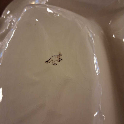 White ceramic plate with a small black design on a white background