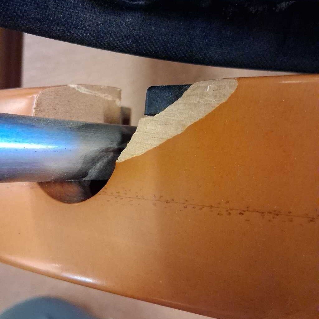 Close-up of a metal tool being used on a wooden surface