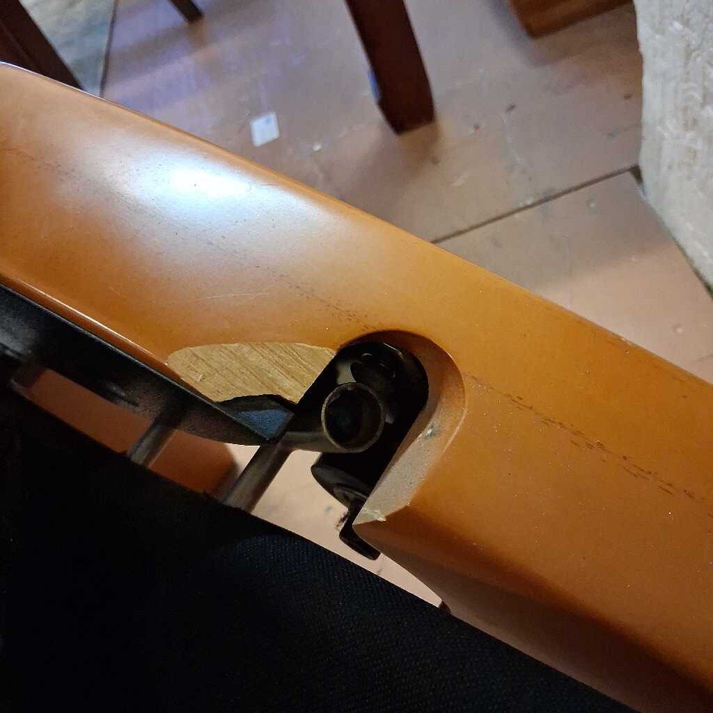 Close-up of a brown object with a reflective surface on a tiled floor.