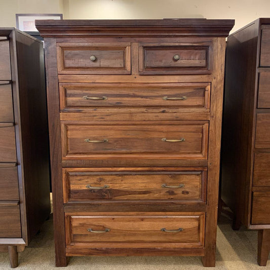 Wooden dresser with multiple drawers in a room setting