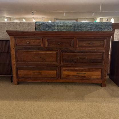 Wooden dresser with multiple drawers in a store setting