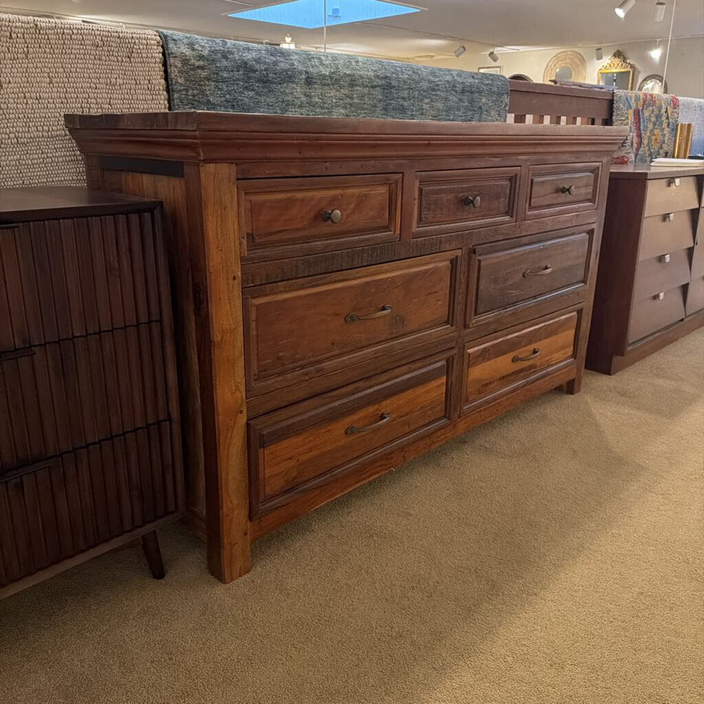 Wooden dresser with multiple drawers in a store setting
