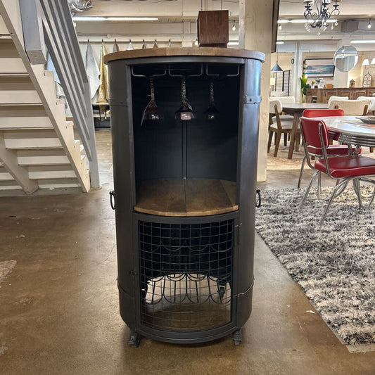 Round wine rack with wooden top and metal wire basket in a showroom setting