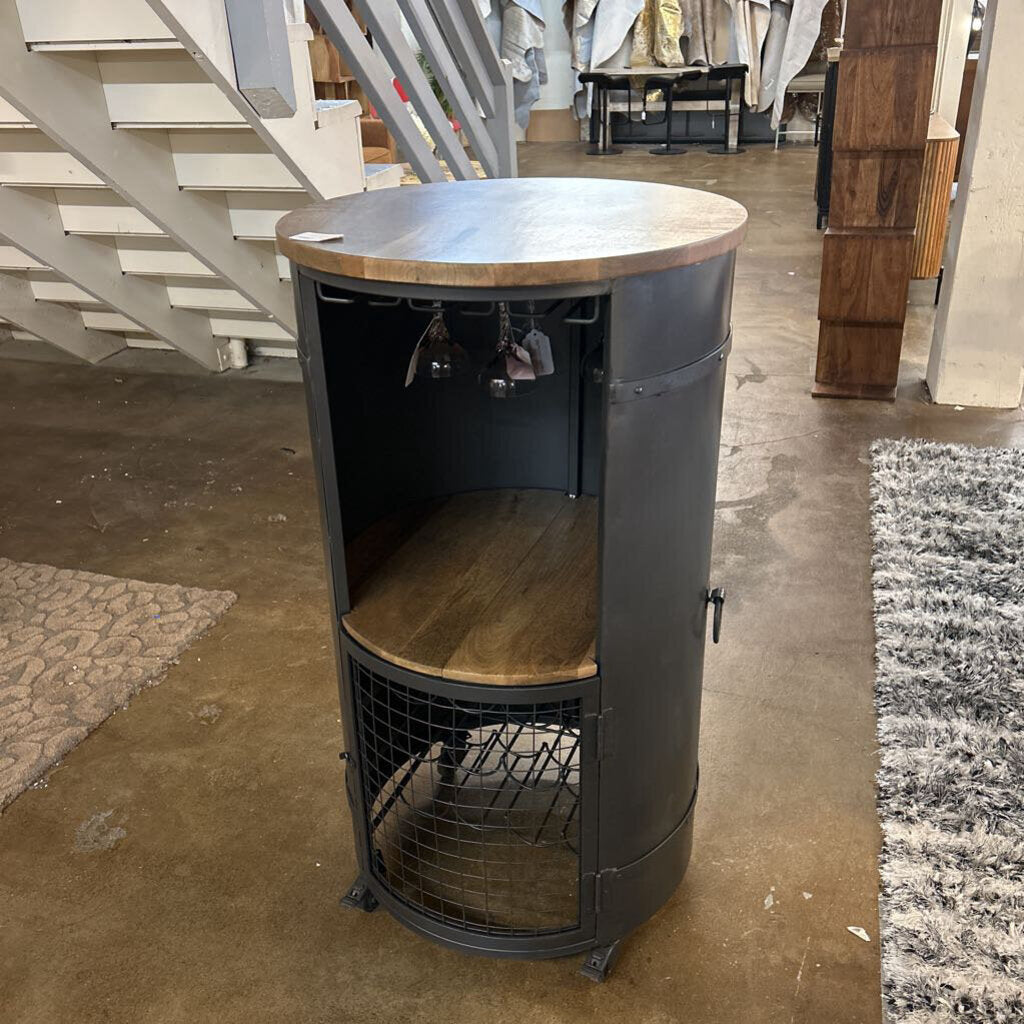 Round wooden table with metal base in a store setting