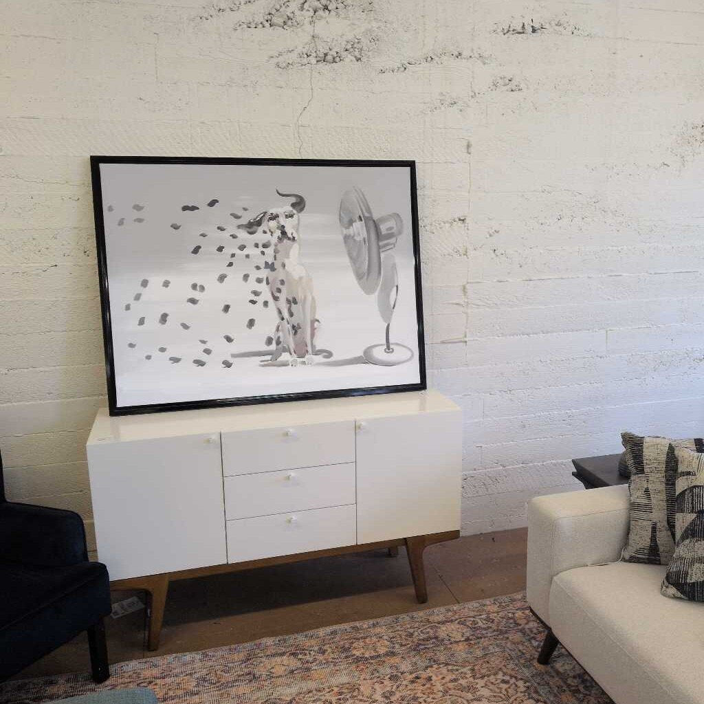White entertainment console with a TV displaying an abstract design in a living room.