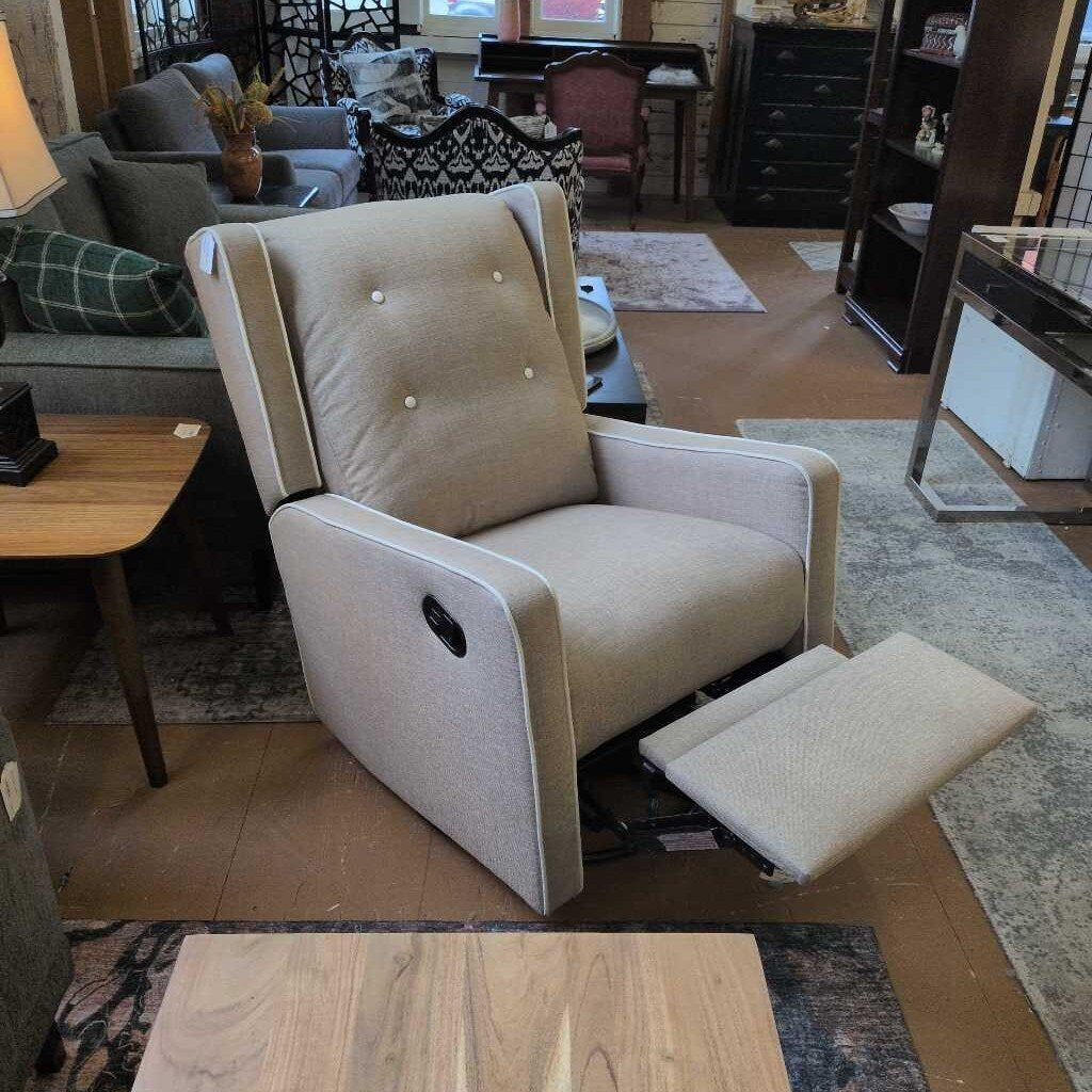 Beige recliner chair in a living room setting with furniture and decor.