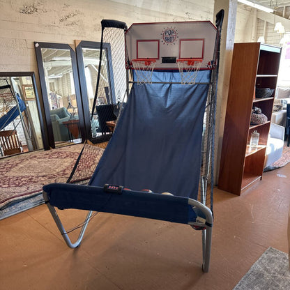 Portable basketball hoop with blue net in a store setting