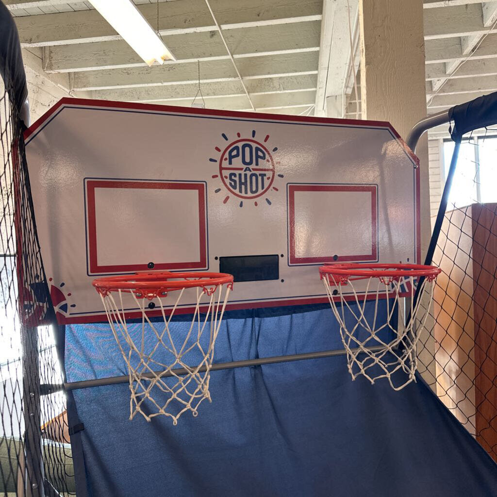 Basketball hoop with two backboards and Pop Shot logo on a blue background.