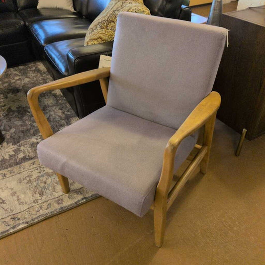 Chair with gray cushion and wooden frame in a room setting