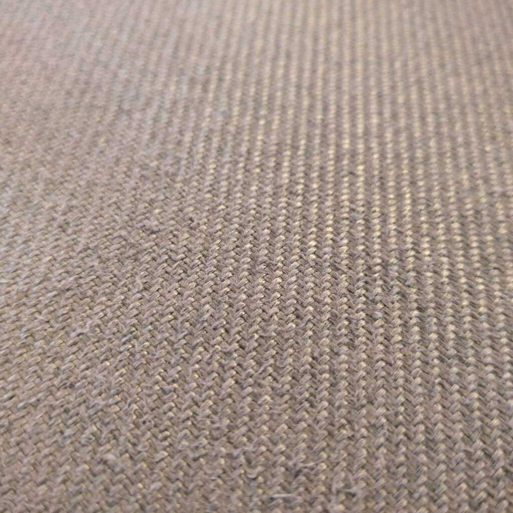 Close-up of a textured brown fabric surface