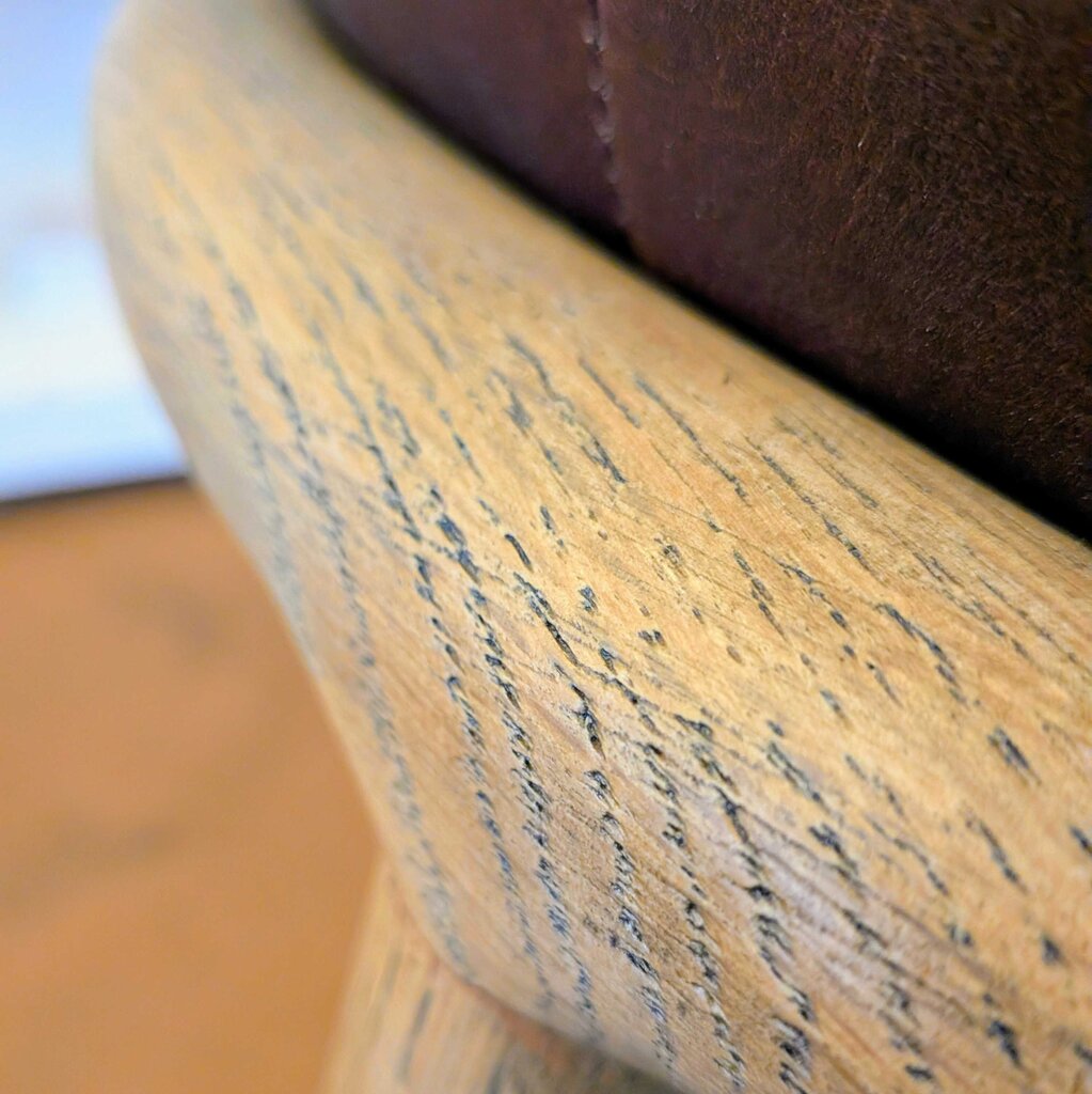 Close-up of a wooden chair with visible grain and texture.