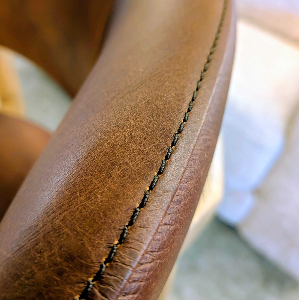 Close-up of brown leather with visible stitching