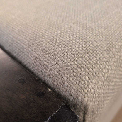 Close-up of a textured fabric surface with a visible seam.