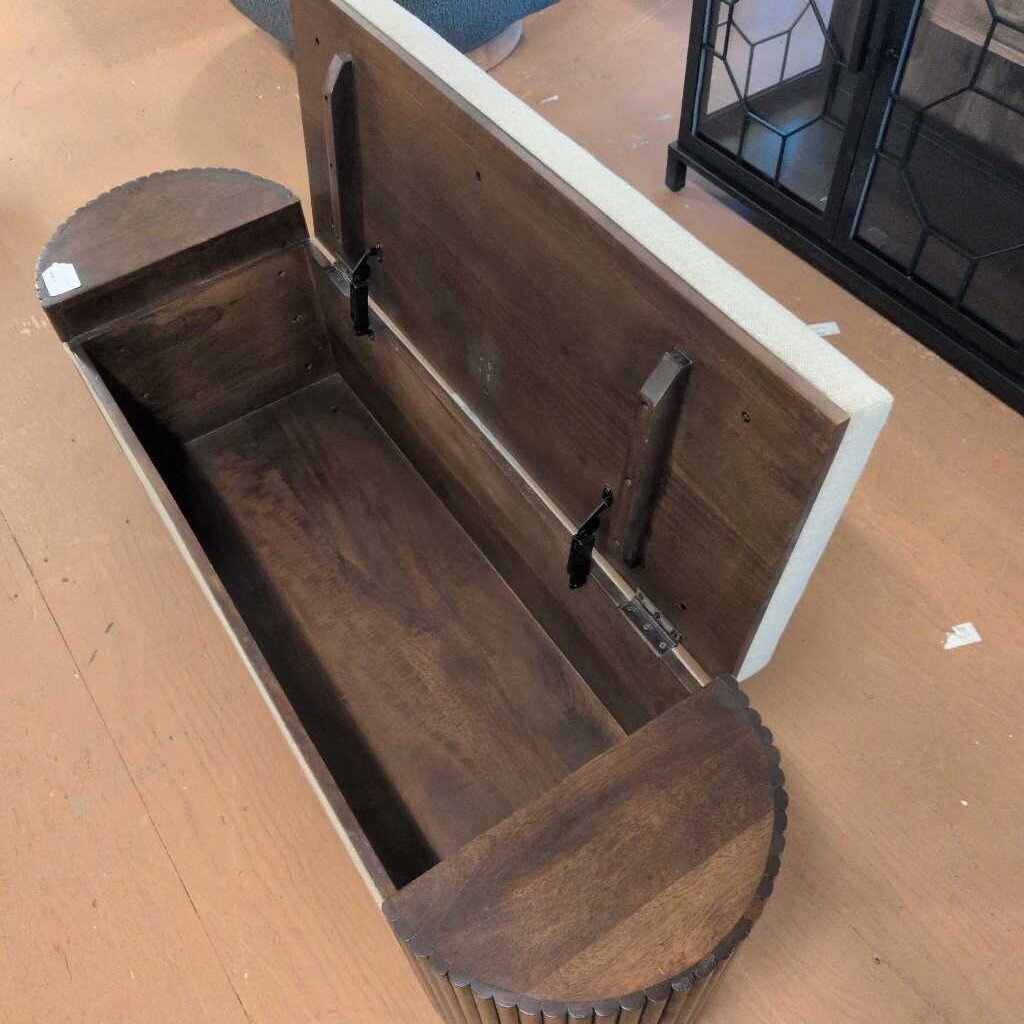 Wooden bench with a curved design on a wooden floor