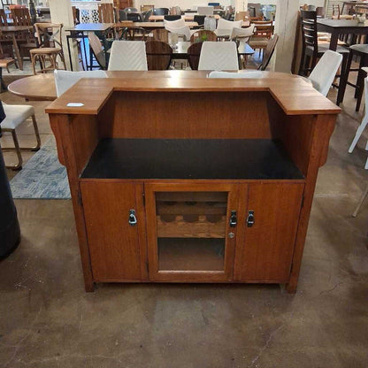 Wooden reception desk with glass front panel in a showroom setting
