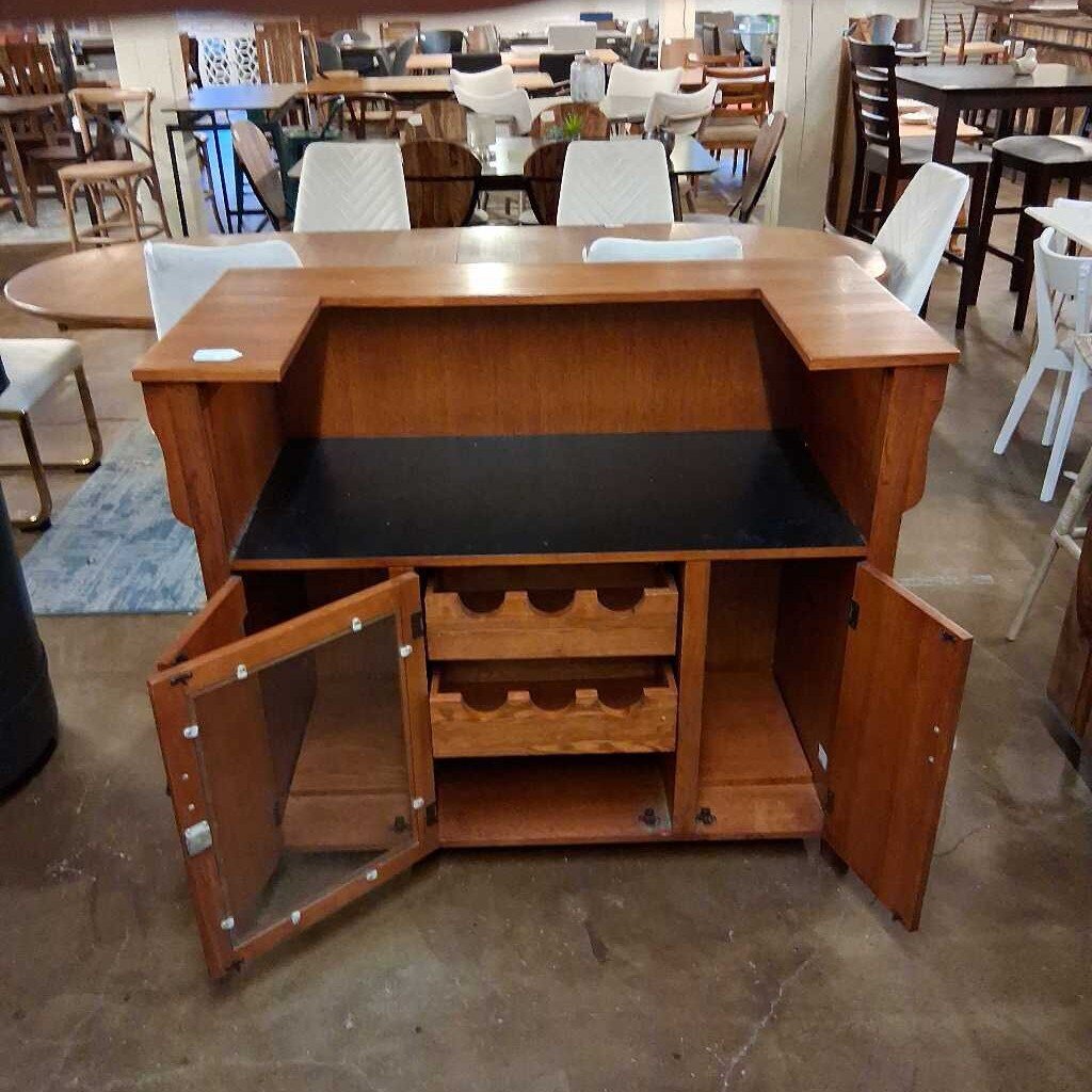 Wooden bar counter with open doors in a showroom setting