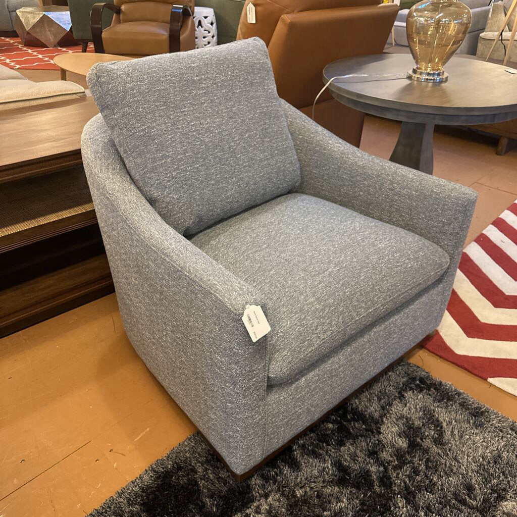 Gray armchair with a price tag in a showroom setting