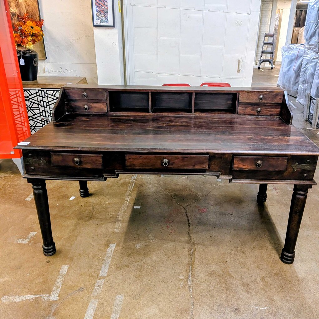 Wooden desk with multiple drawers in a room setting