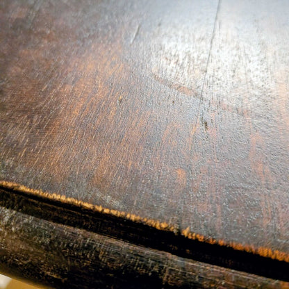 Close-up of a wooden surface with visible grain and wear.
