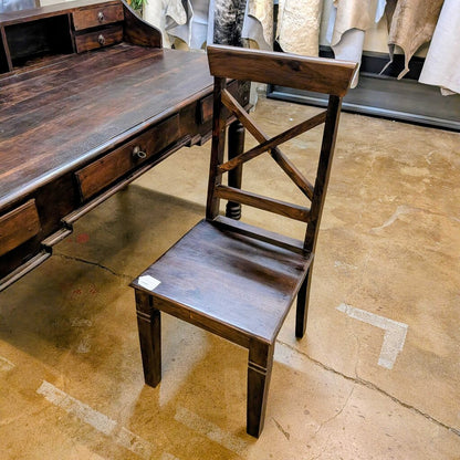 Wooden desk with chair on a concrete floor