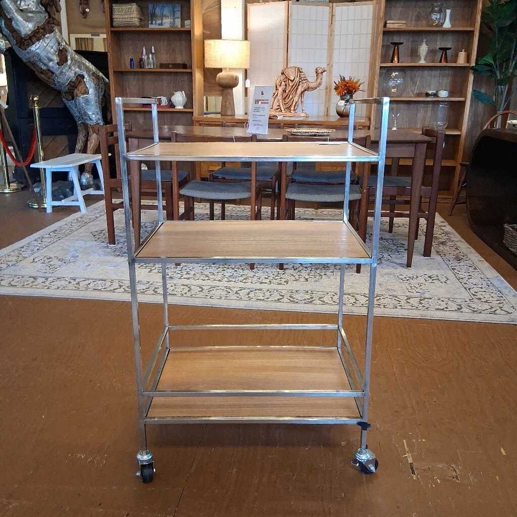 Metal serving cart in a room with a dining table and chairs.