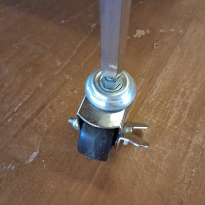 Metal caster wheel on a wooden floor