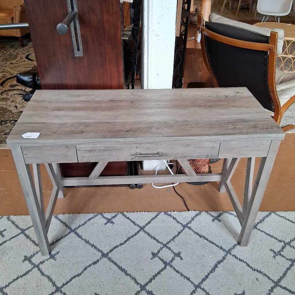 Wooden console table with a drawer on a patterned rug
