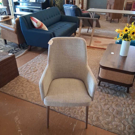 Beige chair in a room with furniture and decor