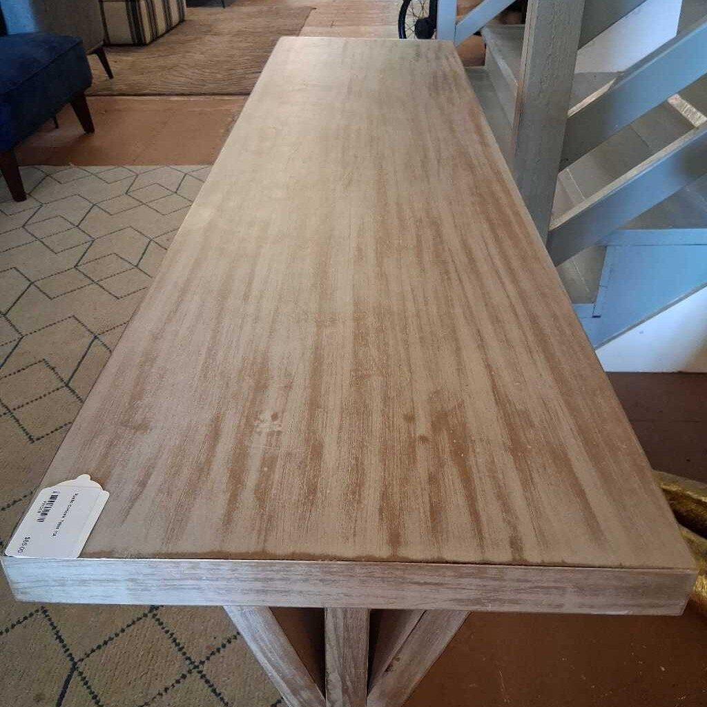 Wooden table with a visible price tag in an indoor setting