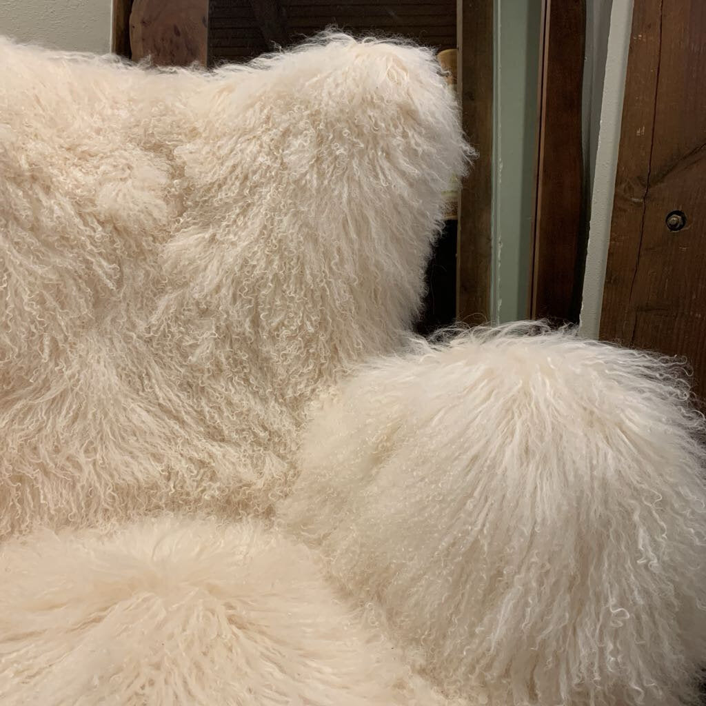 Close-up of a fluffy white pillow against a wooden background