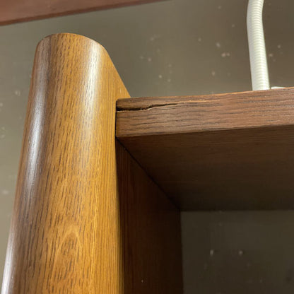 Close-up of a wooden chair arm with a visible crack.