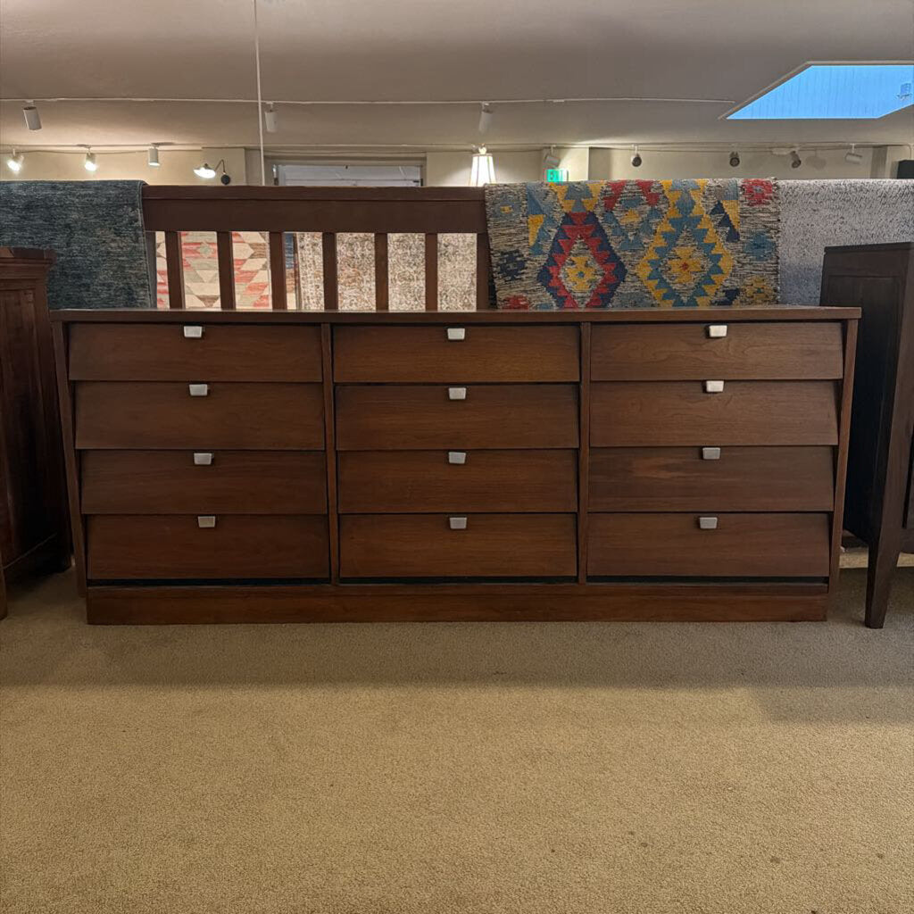 Wooden dresser with multiple drawers in a room setting