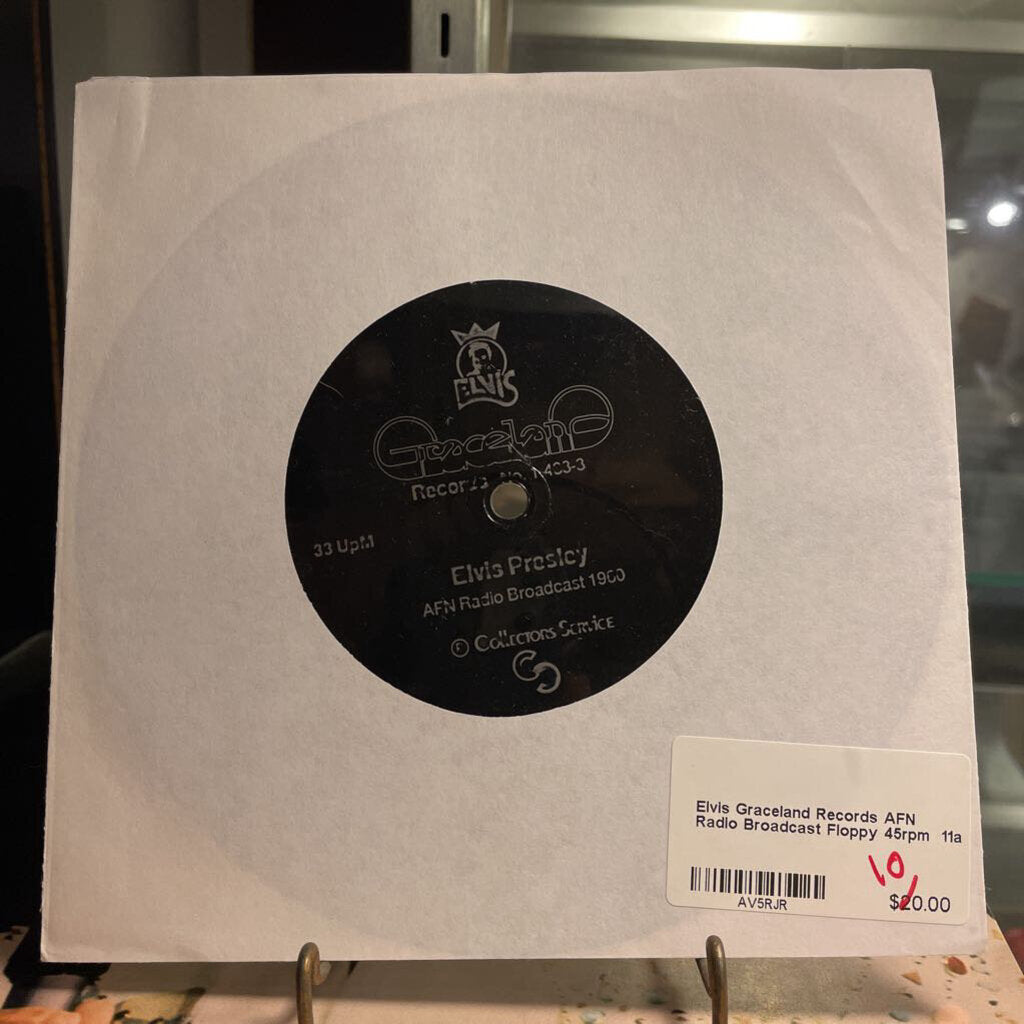 Record cover with a black label featuring 'Elvis Presley' on a white background