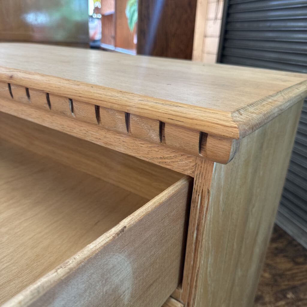 Close-up of a wooden shelf with a blurred background