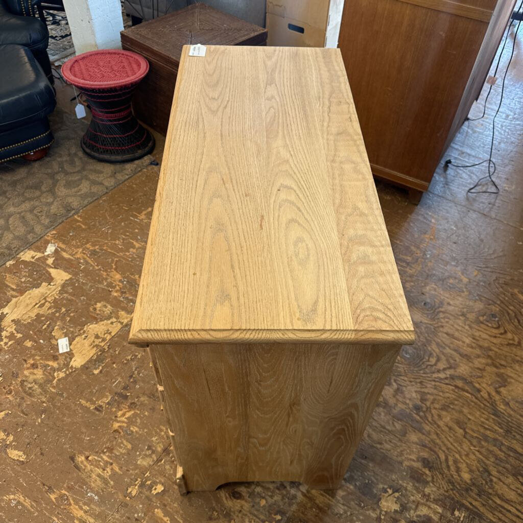 Wooden box on a wooden floor with other furniture items in the background