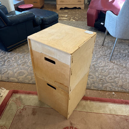 Wooden box on a carpeted floor in a room with furniture