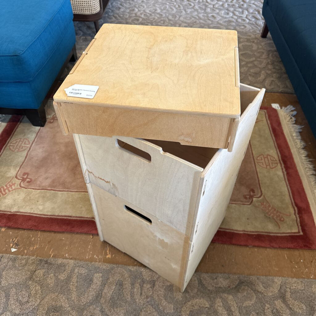 Wooden storage box with a lid on a carpeted floor
