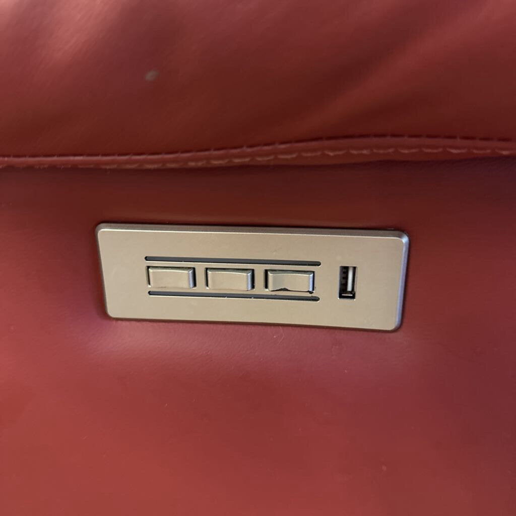 Red leather bag with a gold metal logo