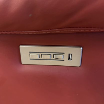 Red leather bag with a gold metal logo