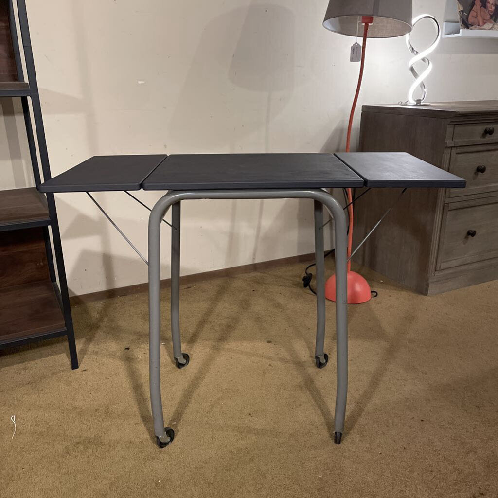 Foldable table with wheels in a room setting