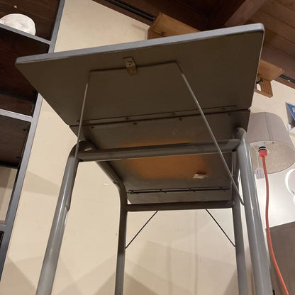 Metal step ladder in a room with wooden beams and a light fixture.